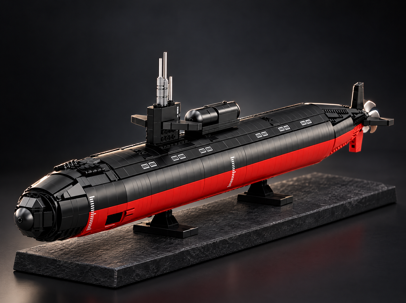 Model submarine on a dark slate display base, studio lighting