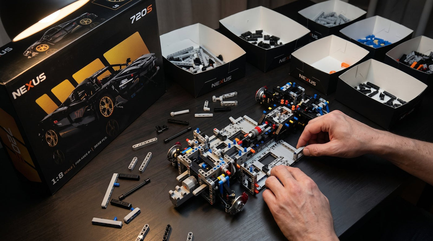 Hands assembling the Zenith 720S brick chassis with sorted organizer trays